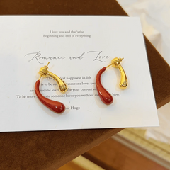 Angled view of the 14K Gold-Plated Red And Golden Water Drop Earrings