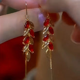 Pair of Red Leaf Gold Tassel Drop Dangle Earrings Handheld Close-up