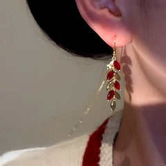Red leaf gold long ear threader dangle earring worn on woman's ear