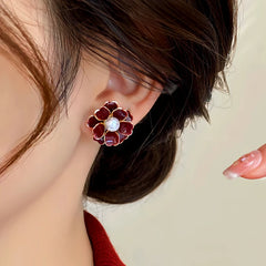 Model showcasing the dangle and style of the 14K Gold-Plated Red Flower Pearl Stud Earrings