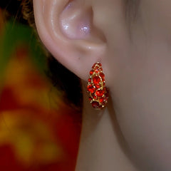 Model showcasing the dangle and style of the 14K Gold-Plated Red Full Diamond Zircon Hoop Earrings