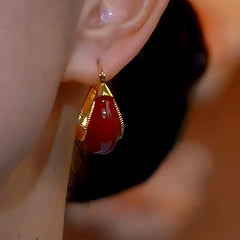 Model showcasing the dangle and style of the 14K Gold-Plated Red Gourd Earrings