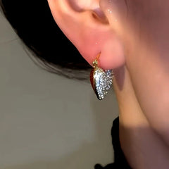 Close-up detail of the sparkling zircons and plating on the Red Heart Earrings