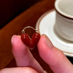 Angled view of the 14K Gold-Plated Red Oil Drop Diamond Heart Earrings