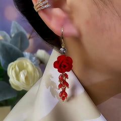 Model showcasing the dangle and style of the 14K Gold-Plated Red Rose Tassel Ear Hooks