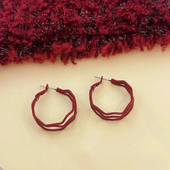 Angled view of the 14K Gold-Plated Red Wavy Three-Layer Hoop Earrings
