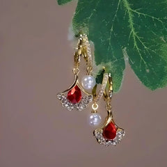 Angled view of the 14K Gold-Plated Red Zircon Pearl Gingko Leaf Earrings