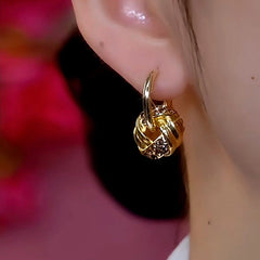 Model showcasing the dangle and style of the 14K Gold-Plated Ring Hoop Earrings
