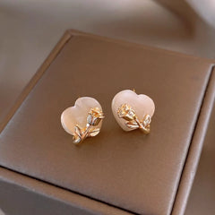 Angled view of the 14K Gold-Plated Rose Heart Stud Earrings