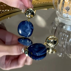 Close-up detail of the sparkling zircons and plating on the Geometric Irregular Earrings