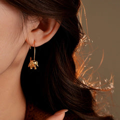 Close-up detail of the sparkling zircons and plating on the Dog Threader Earrings