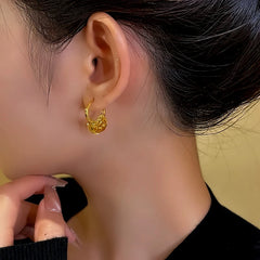Model showcasing the dangle and style of the 14K Gold-Plated Sequin Hoop Tassel Earrings