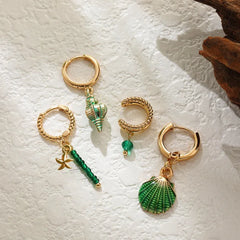 Model showcasing the dangle and style of the 14K Gold-Plated Shell Earrings Set