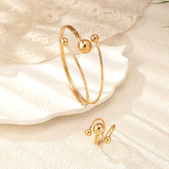 Model wearing the 14K Gold-Plated Simple Ball Bracelet And Ring Set to highlight its design on the wrist