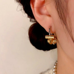 Close-up detail of the sparkling zircons and plating on the C-Shaped Hoops