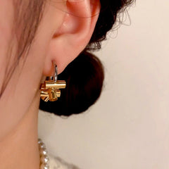Model showcasing the dangle and style of the 14K Gold-Plated Simple C-Shaped Earrings
