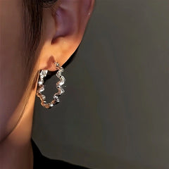 Model showcasing the dangle and style of the 14K Gold-Plated Sparkling Diamond Hoop Earrings