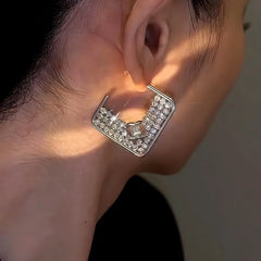 Model showcasing the dangle and style of the 14K Gold-Plated Square Diamond Earrings