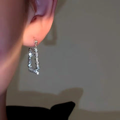 Close-up detail of the sparkling zircons and plating on the Square Gold Earrings