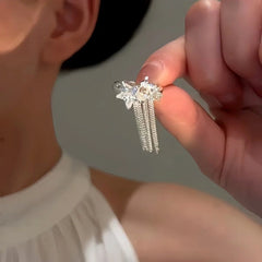Close-up detail of the sparkling zircons and plating on the Star Tassel Ear Clips