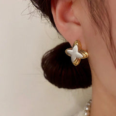Close-up detail of the sparkling zircons and plating on the Star Stud Earrings