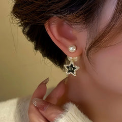 Model showcasing the dangle and style of the 14K Gold-Plated Star Tassel Bead Earrings