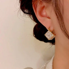 Close-up detail of the sparkling zircons and plating on the 3D Square Earrings