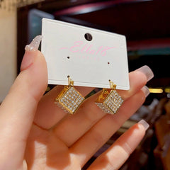 Angled view of the 14K Gold-Plated Three-Dimensional Square Earrings