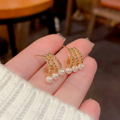 Close-up detail of the sparkling zircons and plating on the Hollow Pearl Earrings