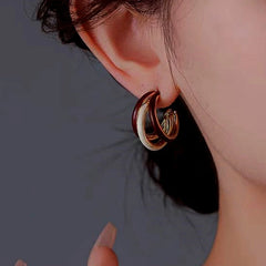 Model showcasing the dangle and style of the 14K Gold-Plated Three Layer Earrings