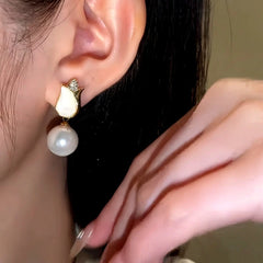 Angled view of the 14K Gold-Plated Tulip Pearl Earrings And Necklace Set