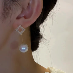 Close-up detail of the sparkling zircons and plating on the Square Pearl Earrings