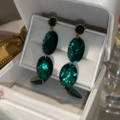 Close-up detail of the sparkling zircons and plating on the Emerald Oval Earrings