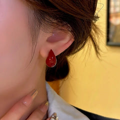 Model showcasing the dangle and style of the 14K Gold-Plated Water Drop Stud Earrings