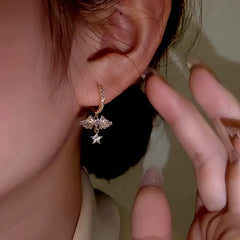 Model showcasing the dangle and style of the 14K Gold-Plated Zircon Angel Wing Earrings
