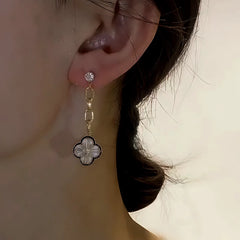 Model showcasing the dangle and style of the 14K Gold-Plated Zircon Asymmetrical Four-Leaf Flower Earring