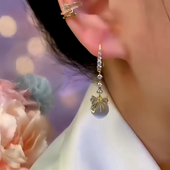 Close-up detail of the sparkling zircons and plating on the Bow Ear Hook Earrings