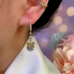 Model showcasing the dangle and style of the 14K Gold-Plated Zircon Bead Bow Ear Hook Earrings