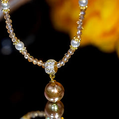 Detailed view of the 14K Gold-Plated Zircon Beads Brown Pearl Necklace chain and pendant