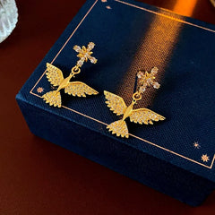 Model showcasing the dangle and style of the 14K Gold-Plated Zircon Bird Earrings
