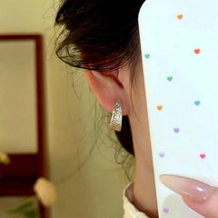 Model showcasing the dangle and style of the 14K Gold-Plated Zircon Bling Bling C-Shaped Earrings
