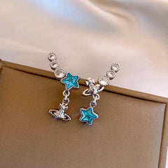 Model showcasing the dangle and style of the 14K Gold-Plated Zircon Blue Star Tassel Earrings