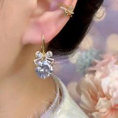 Model showcasing the dangle and style of the 14K Gold-Plated Zircon Bow Ear Hooks