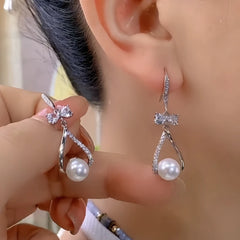 Angled view of the 14K Gold-Plated Zircon Bow Pearl Ear Hook Earrings