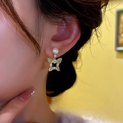 Model showcasing the dangle and style of the 14K Gold-Plated Zircon Butterfly Bead Earrings