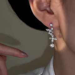 Model showcasing the dangle and style of the 14K Gold-Plated Zircon Butterfly Earrings