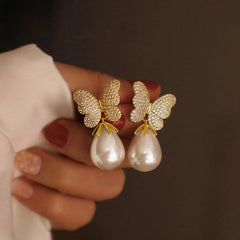 Angled view of the 14K Gold-Plated Zircon Butterfly Pearl Earrings