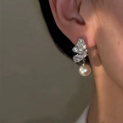 Close-up detail of the sparkling zircons and plating on the Butterfly Pearl Earrings