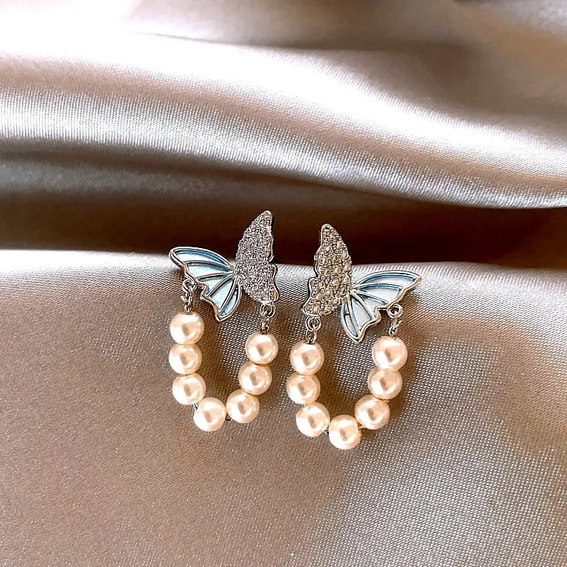 Angled view of the 14K Gold-Plated Zircon Butterfly Pearl Earrings
