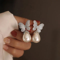 Close-up detail of the sparkling zircons and plating on the Butterfly Pearl Earrings